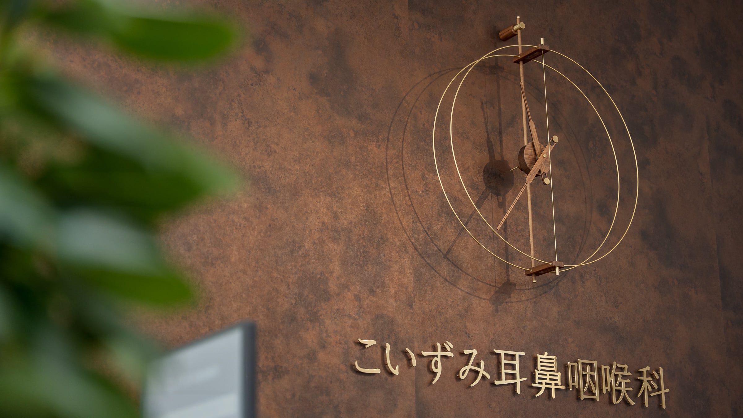院内の壁面に設置された、こいずみ耳鼻咽喉科のロゴサイン